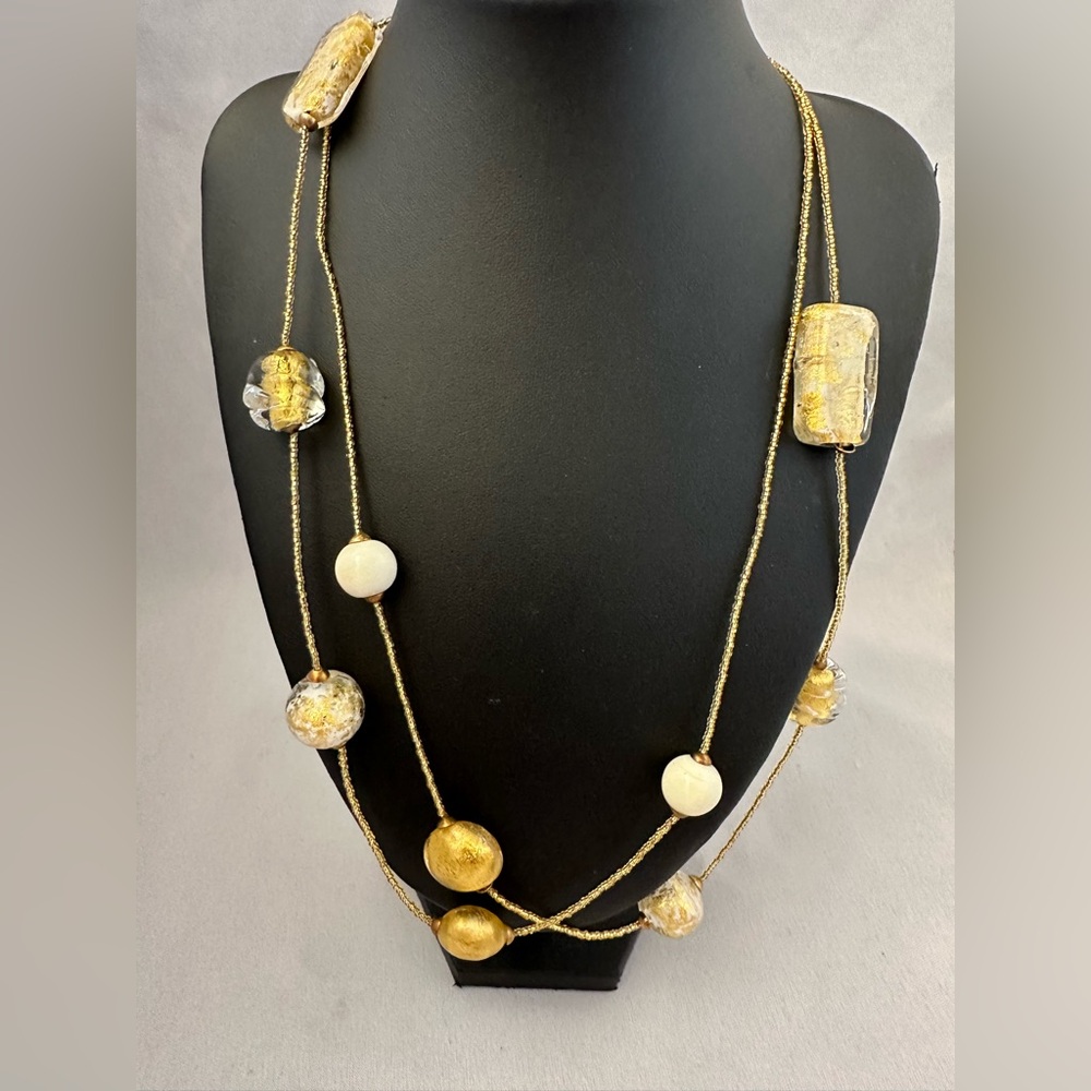 Hilary London long gold tone necklace with withe and gold foil glass beads